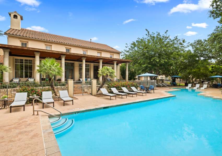 Lounge chairs by the pool at Sedona Ranch Apartments in San Antonio, Texas