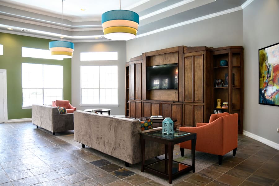 Comfortable couches in front of TV in resident clubhouse at The Club at Stablechase