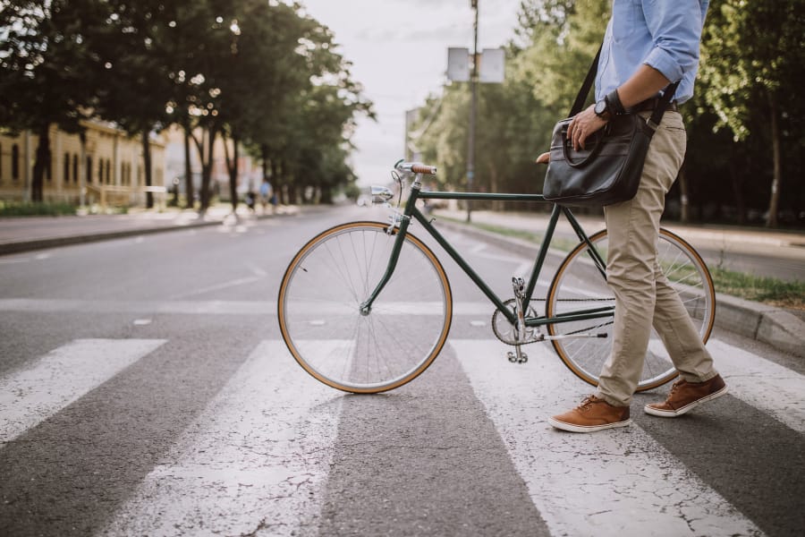 Person walking a bike near Artisan Apartments in Chicago, Illinois