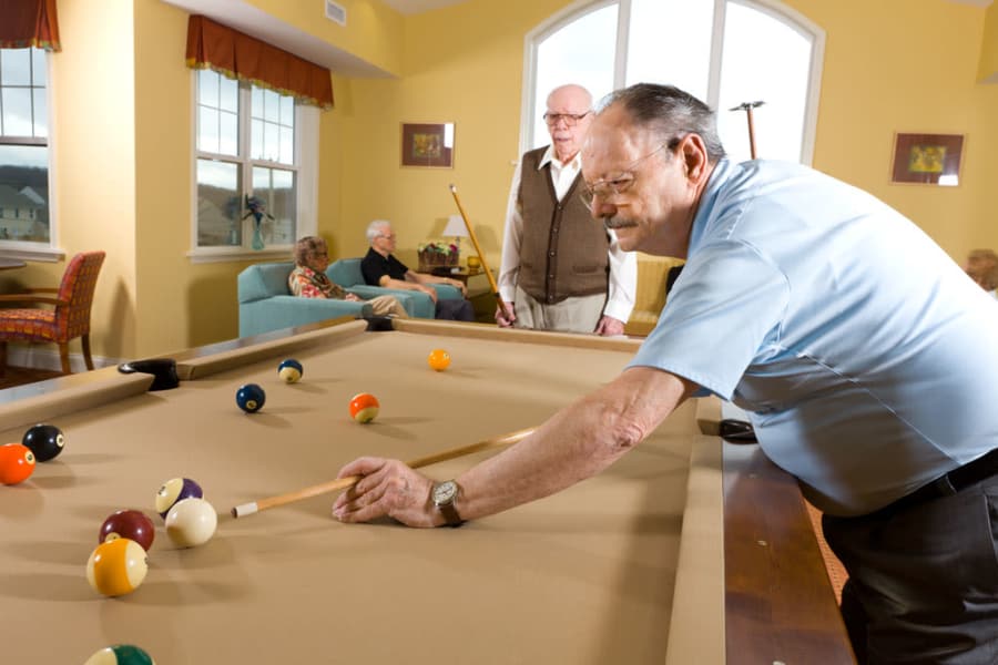 Residents playing pool at The Manor at Market Square in Reading, Pennsylvania