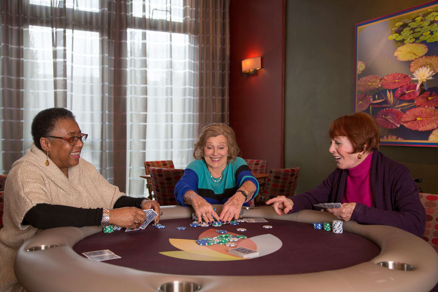 Residents playing cards in the game room at Casa Del Rio Senior Living in Peoria, Arizona