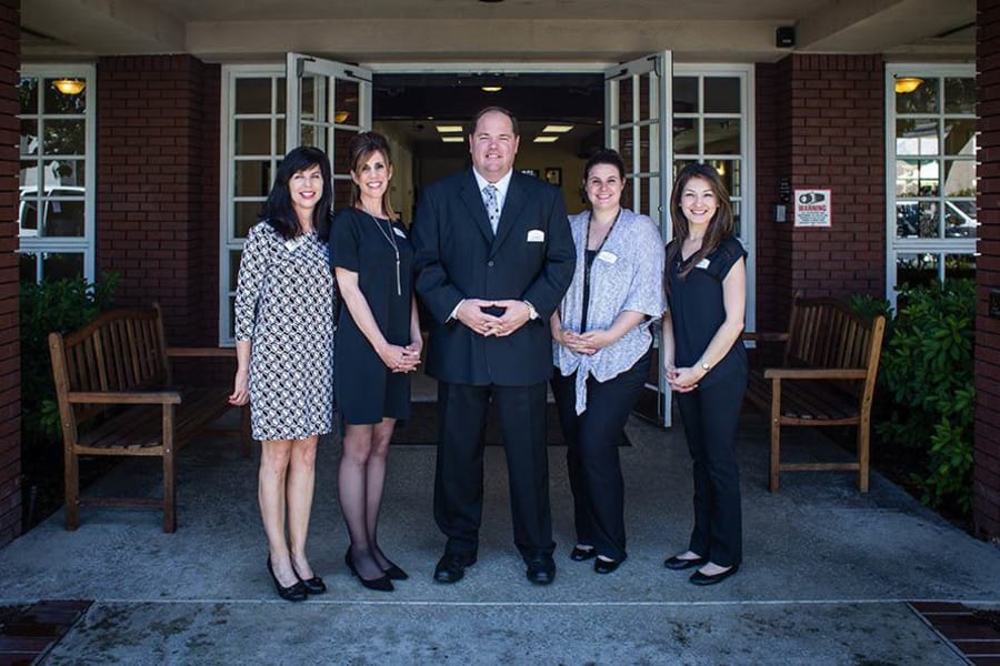Staff posing out front of Carmel Village in Fountain Valley, California