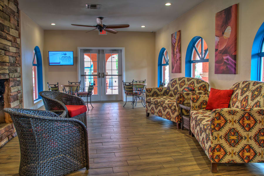 Hardwood floors and comfortable seating in front of the fireplace at Casa Del Rio Senior Living in Peoria, Arizona