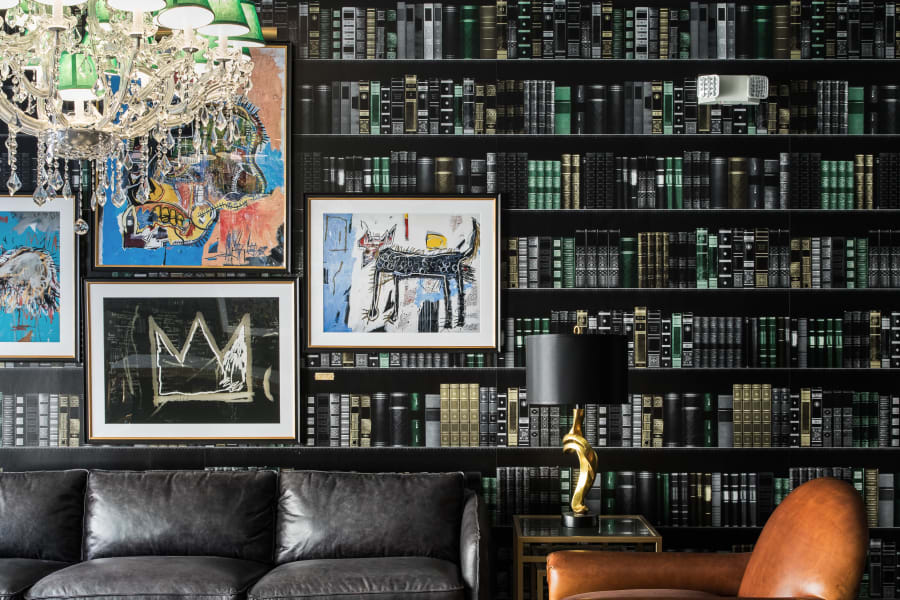 Close-up of the bookshelf decor and leather sofa of a Campus Life & Style Autograph Collection property