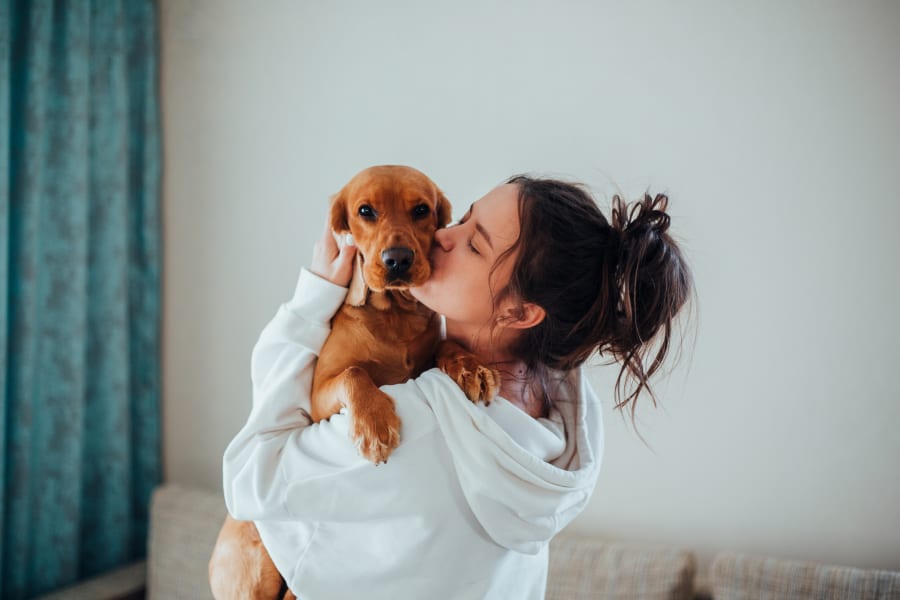 Resident kissing her dog at Aventura Apartments in Tucson, Arizona