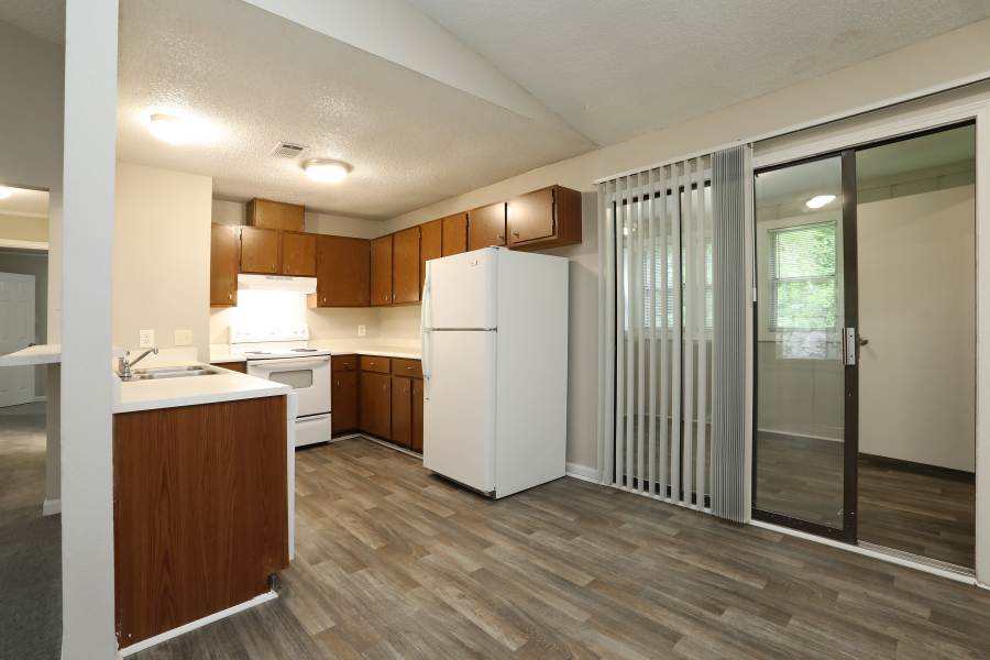 U-shaped apartment kitchen with white appliances at Britain Village in Lawrenceville, Georgia