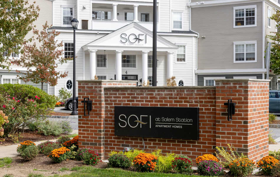 Sign on a Brick Wall Outside of Sofi at Salem Station in Salem, Massachusetts