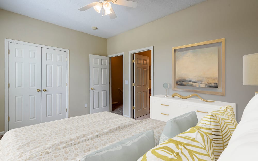Model bedroom with ensuite bathroom at Falls Creek Apartments & Townhomes in Raleigh, North Carolina