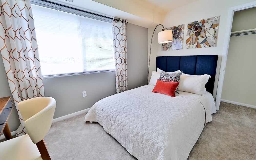 Model bedroom with a large closet and plush carpeting at Villages at Montpelier Apartment Homes in Laurel, Maryland