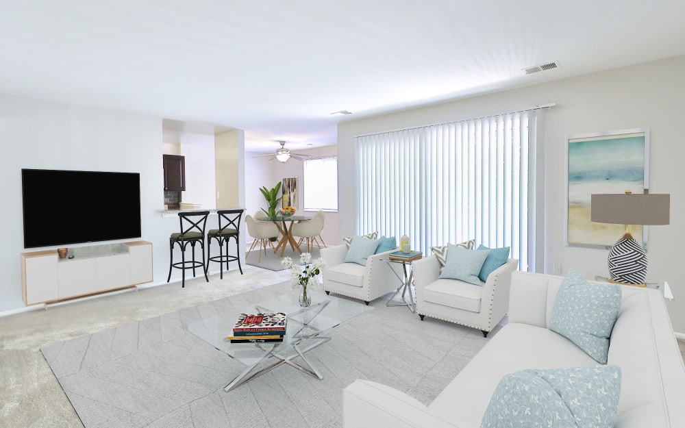 Spacious model living room with sliding door access to a private patio at Skylark Pointe Apartment Homes in Parkville, Maryland