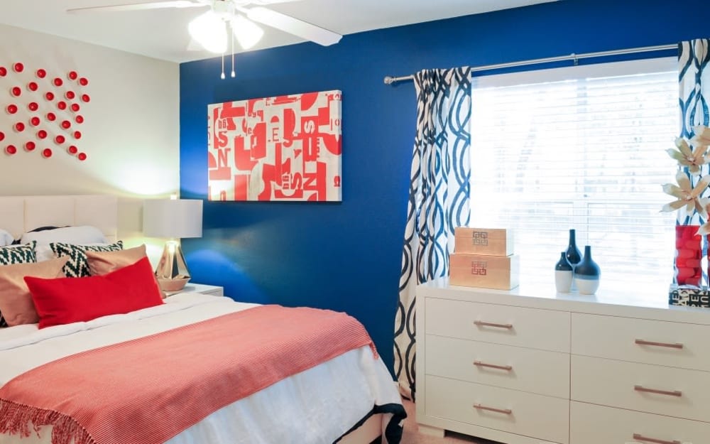 Model bedroom with a ceiling fan in a home at Hampton Greene Apartment Homes in Columbia, South Carolina