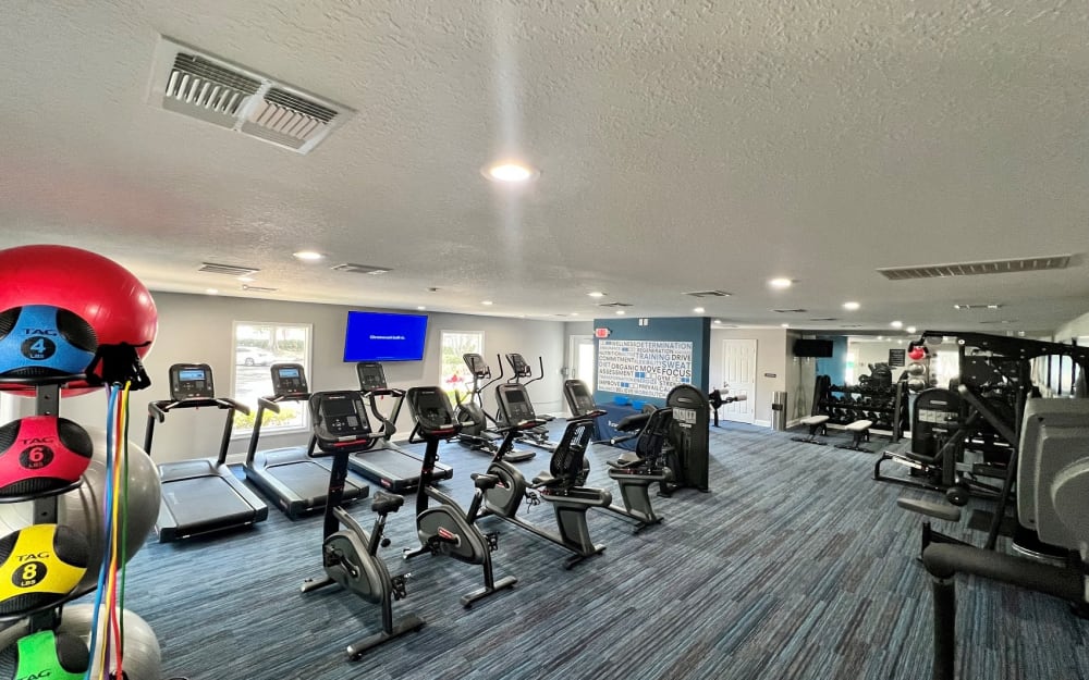 Well-equipped fitness center with cardio equipment at Reserve at Lake Pointe Apartments & Townhomes in St Petersburg, Florida