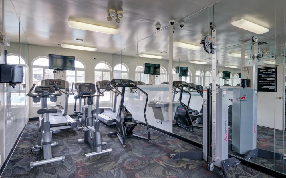 Well-equipped fitness center with cardio equipment at East Meadow Apartments in Fairfax, Virginia