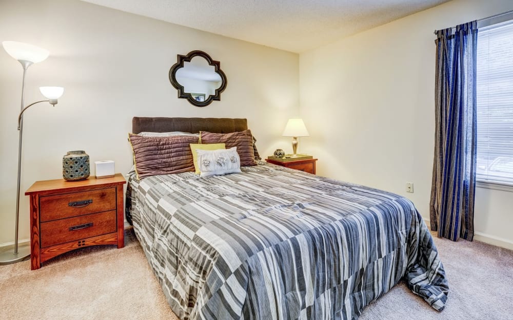Model bedroom with plush carpeting at Chason Ridge Apartment Homes in Fayetteville, North Carolina