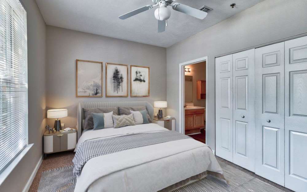 Model bedroom with ensuite bathroom and walk-in closet at Main Street Apartments in Huntsville, Alabama