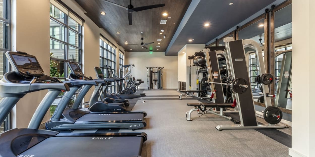 Cardio and weight lifting equipment in the fitness center at Ross + Peak in Dallas, Texas