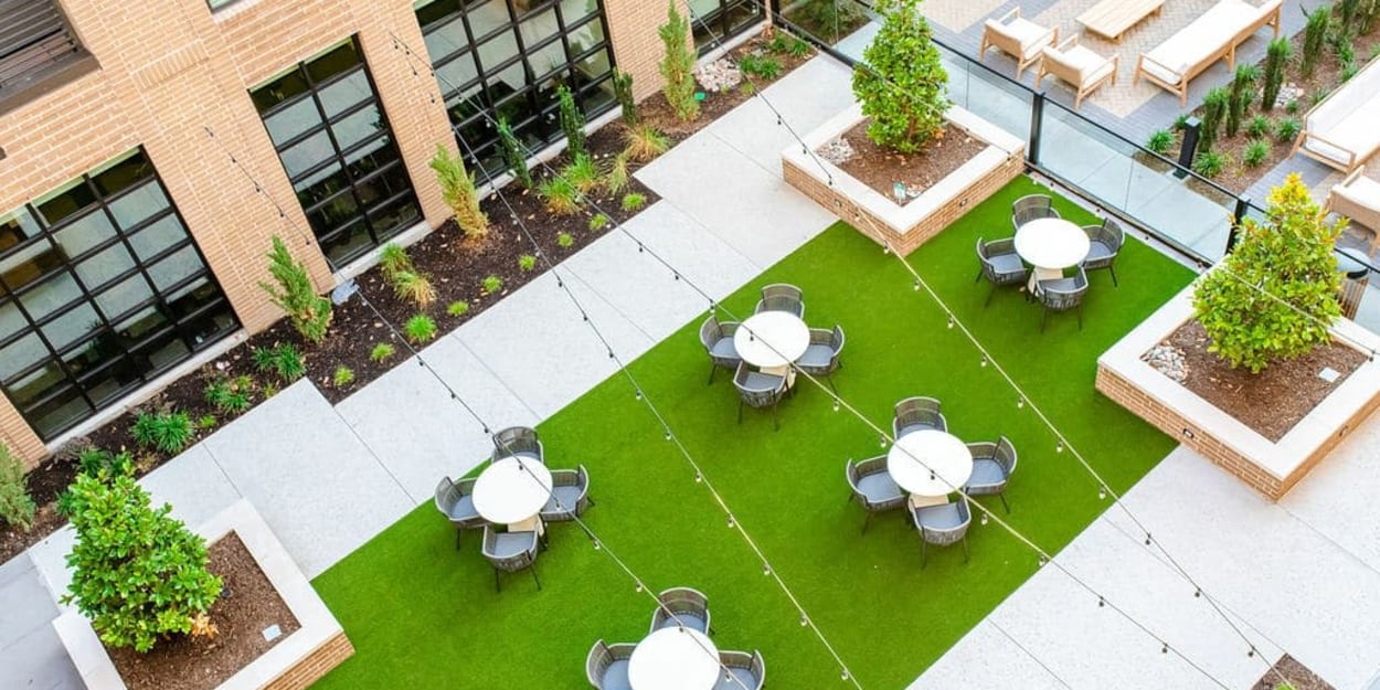 Aerial view of outdoor tables and chairs in the courtyard at Ross + Peak in Dallas, Texas