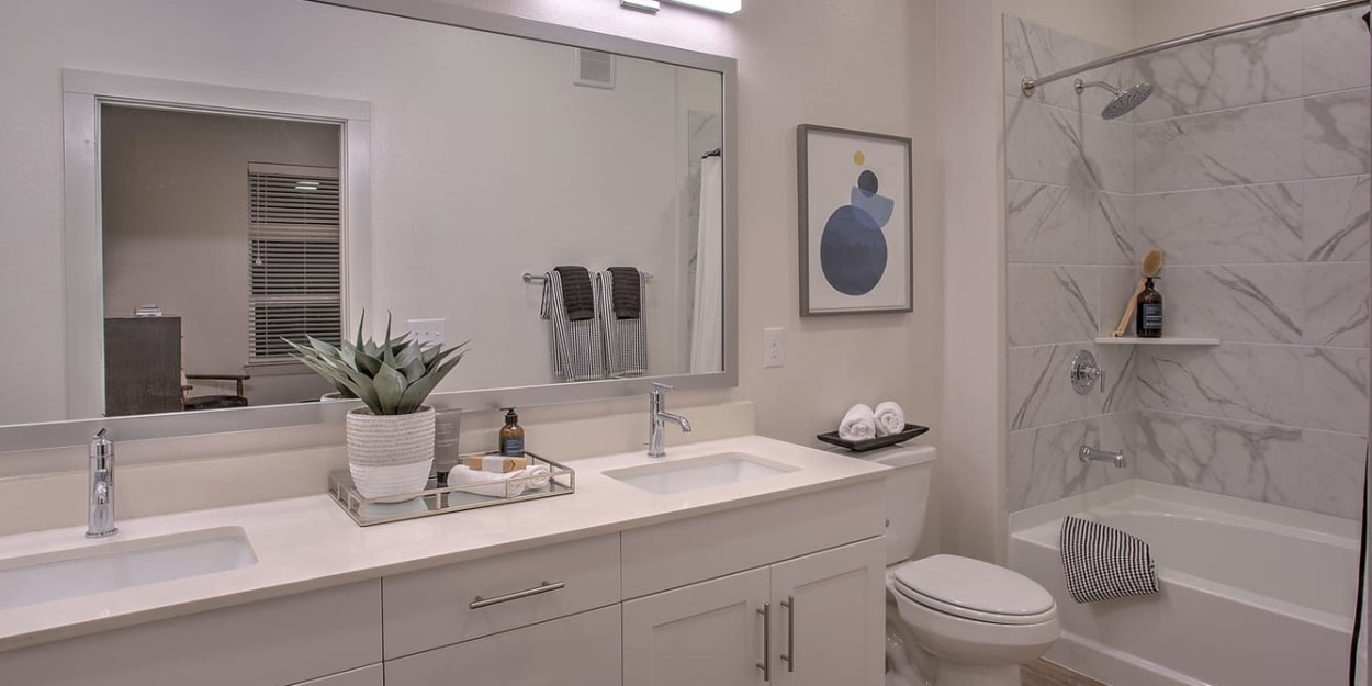 Modern finishes in an apartment bathroom at Ross + Peak in Dallas, Texas