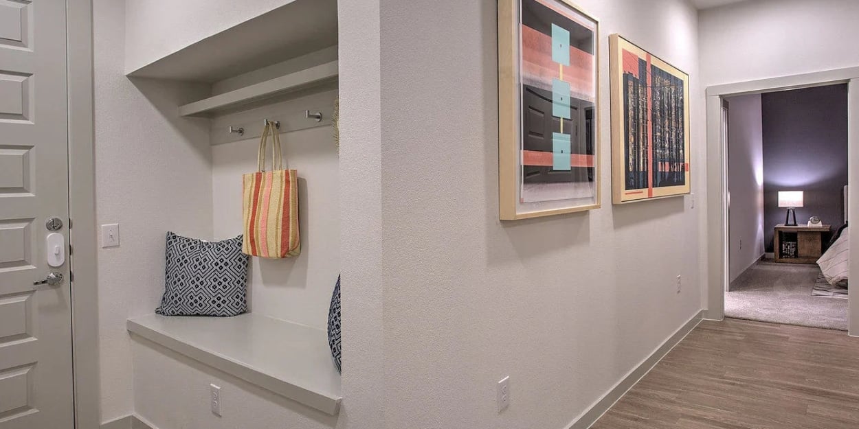 Built-in storage area in an apartment entryway at Ross + Peak in Dallas, Texas
