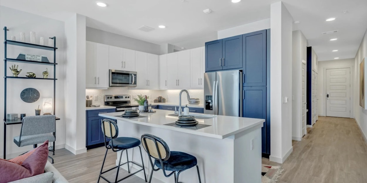 Blue cupboards in an apartment kitchen at Ross + Peak in Dallas, Texas