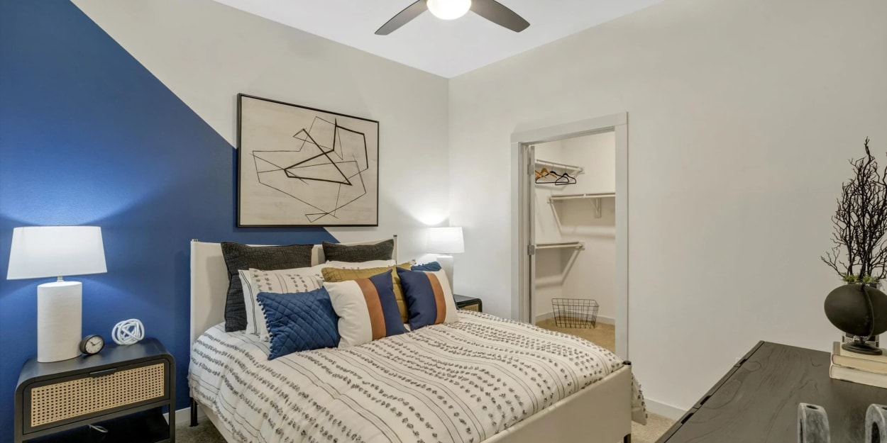 Apartment bedroom with a walk-in closet at Ross + Peak in Dallas, Texas