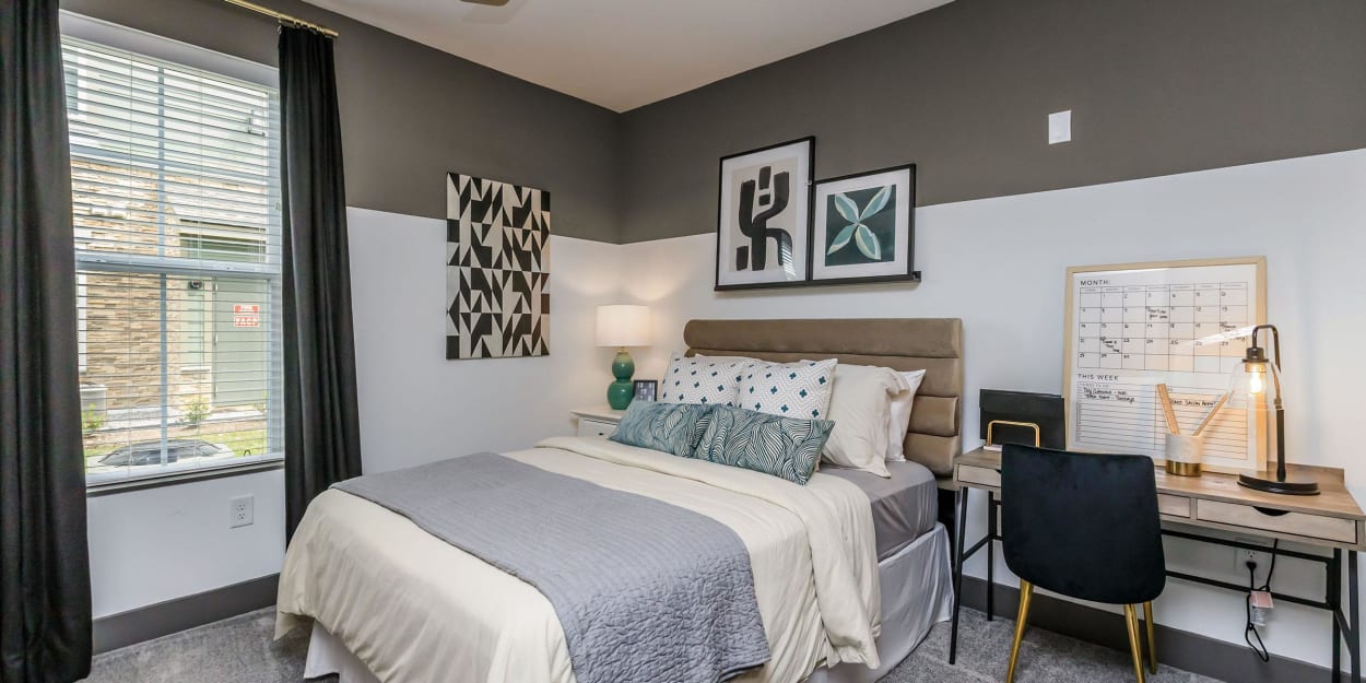 Apartment bedroom with accent paint on the walls at Mandolin at Stream Valley in Franklin, Tennessee