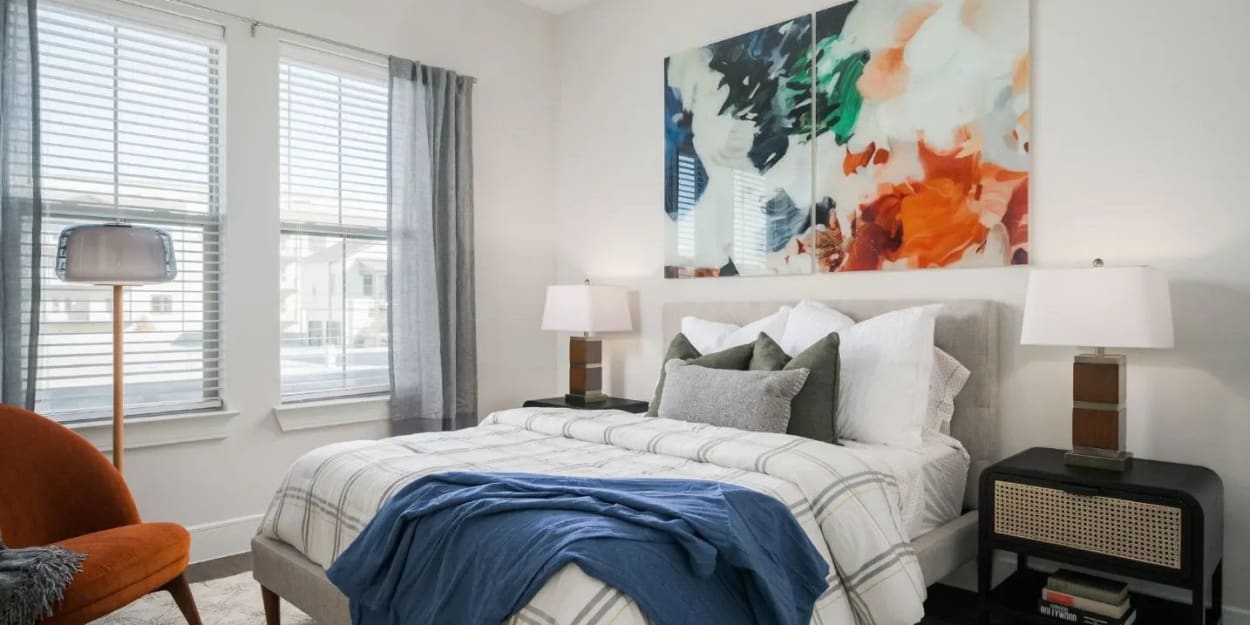 Cozy apartment bedroom with tall ceilings at The Jackson at Viridian in Arlington, Texas