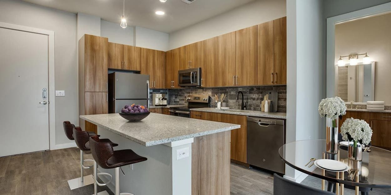 Stainless-steel appliances in a kitchen with an island at The Cooper in Fort Worth, Texas