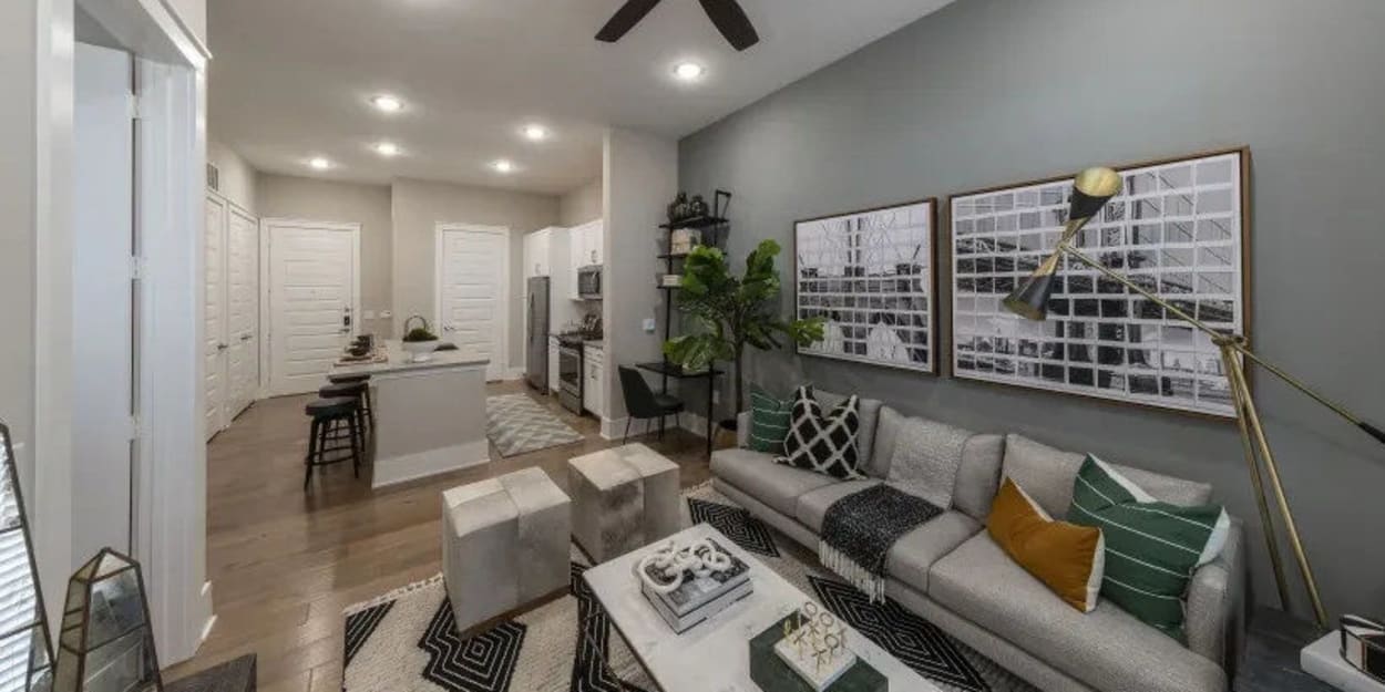 Apartment living room and kitchen with tall ceilings at The Register in Richardson, Texas