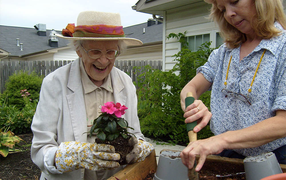 Residents planting together at Heritage Green Assisted Living and Memory Care in Lynchburg, Virginia
