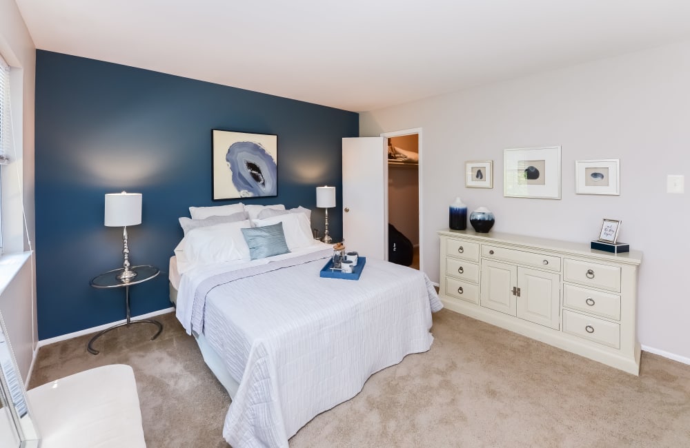 Model bedroom with a blue accent wall at Brookside Manor Apartments & Townhomes in Lansdale, Pennsylvania
