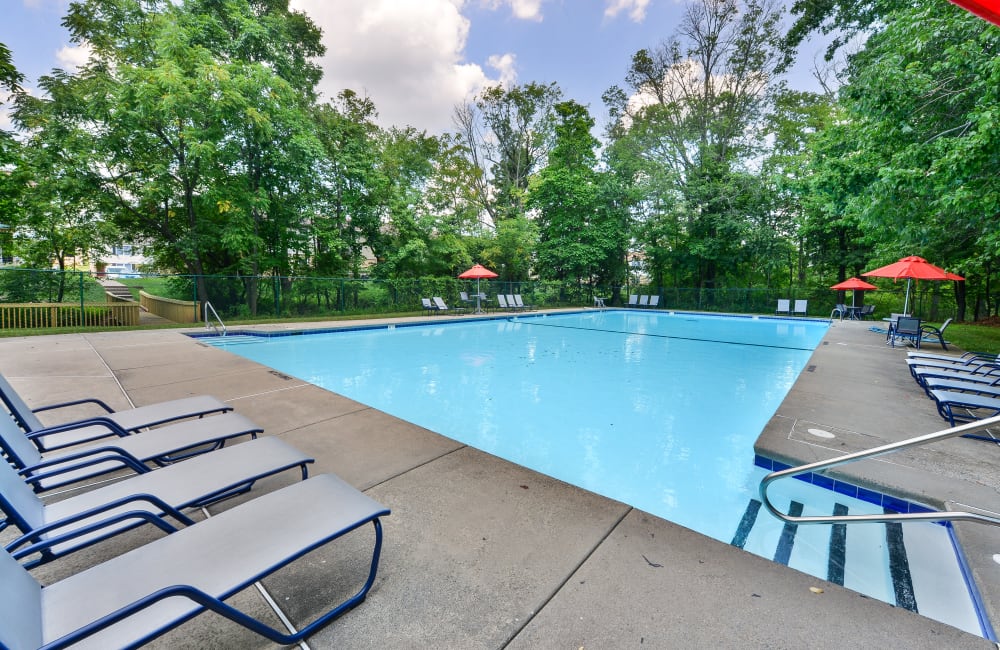 Swimming pool surrounded by lounge chairs at Brookside Manor Apartments & Townhomes in Lansdale, Pennsylvania