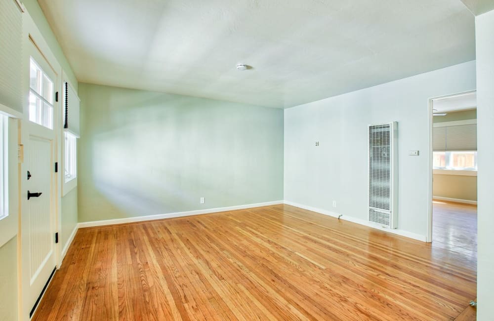 Spacious living room with wood flooring at Hawthorne Apartments in Palo Alto, California