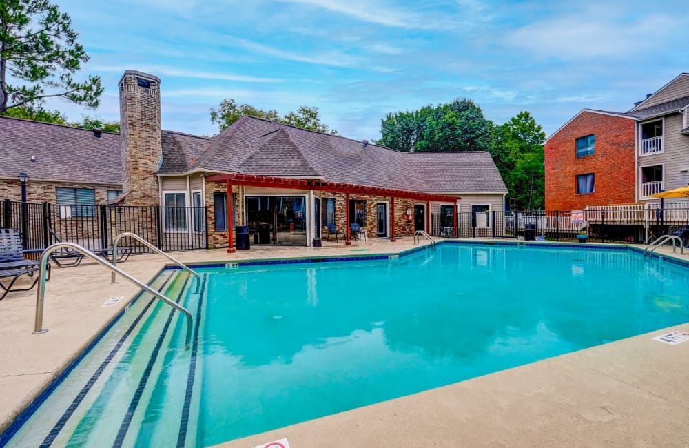 Sparkling swimming pool with clubhouse in background at Gable Hill Apartment Homes in Columbia, South Carolina