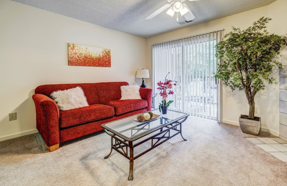 Living room with sliding glass door at Chason Ridge Apartment Homes in Fayetteville, North Carolina