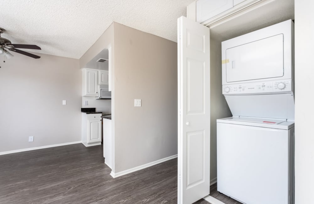 Washer and dryer and kitchen at Sierra Vista Apartments in Redlands, California