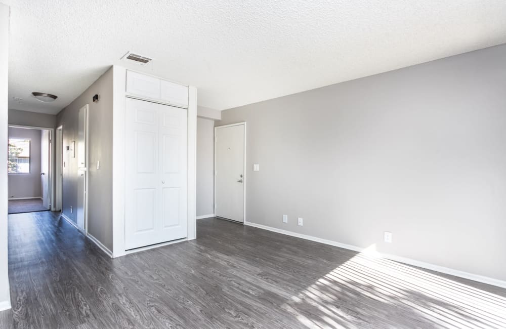 Open room with hardwood floor and white walls at Sierra Vista Apartments in Redlands, California