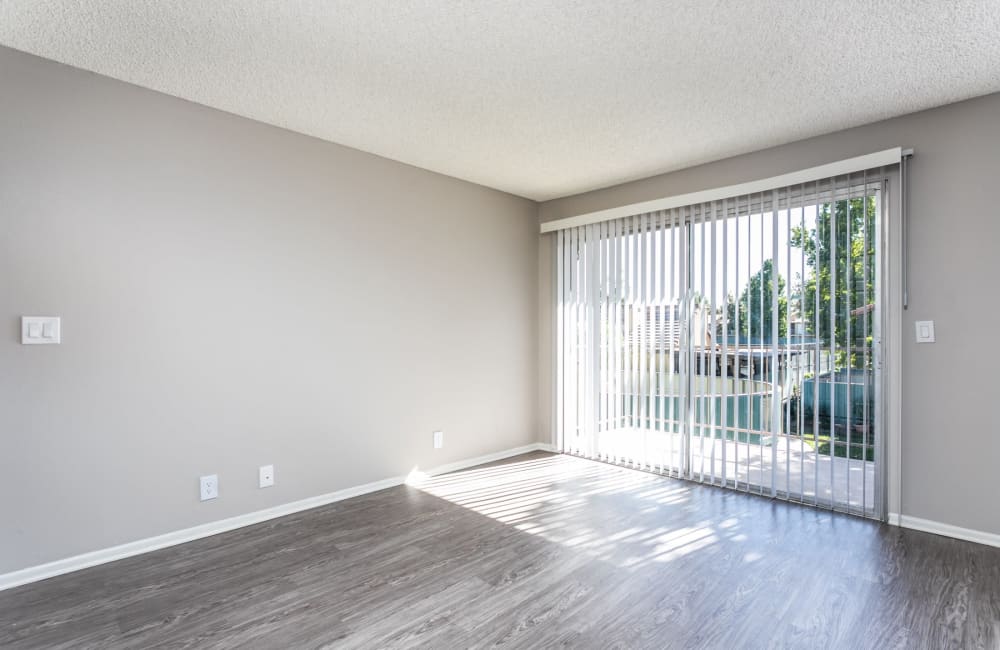 Large open living room with hardwood floors at Sierra Vista Apartments in Redlands, California