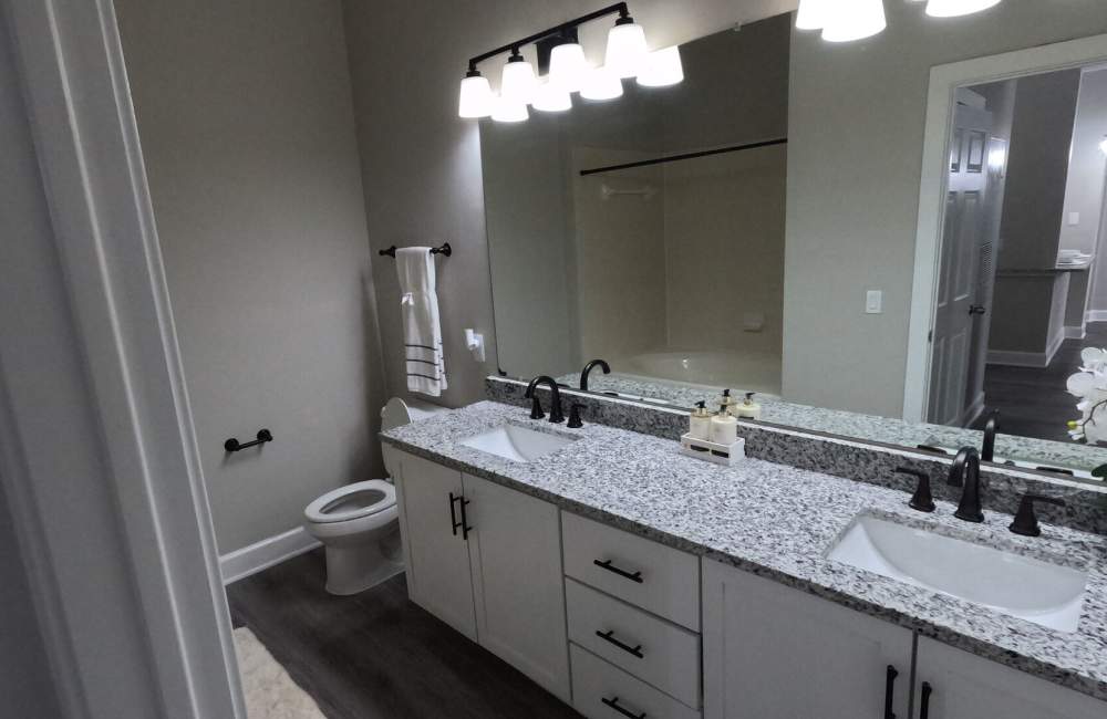 Bright bathroom with vanity lights at Heights on Katy in Houston, Texas, 