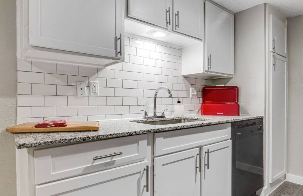 Kitchen with granite countertop and enhanced backsplash at Array in Austin,Texas