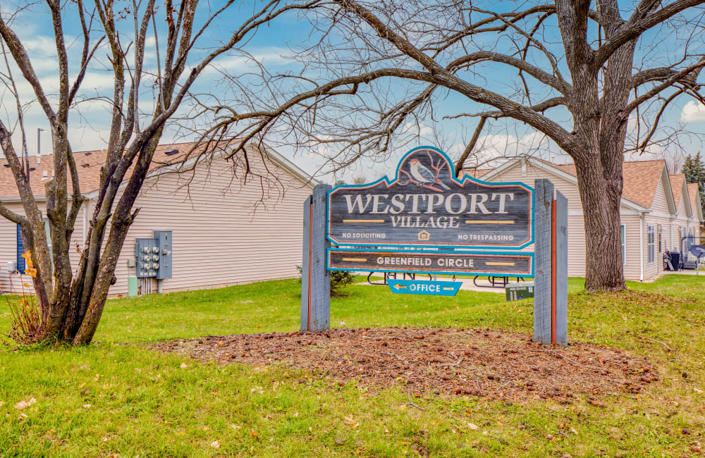 Exterior sign close up at Westport Village Apartments in Freeport, Illinois
