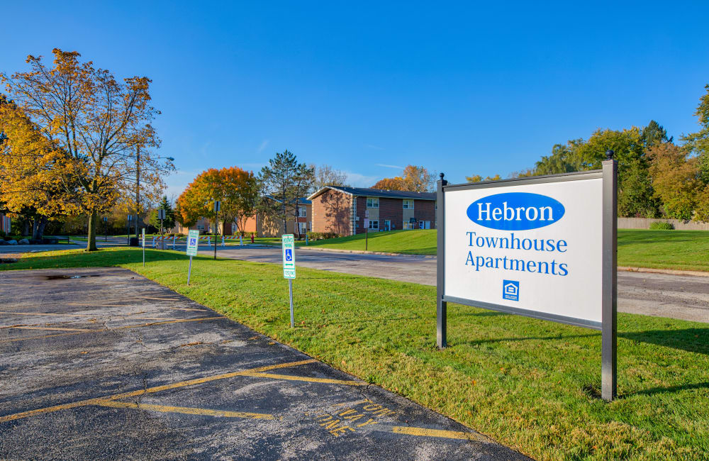 Exterior with sign at Hebron Townhouse Apartments in Zion, Illinois
