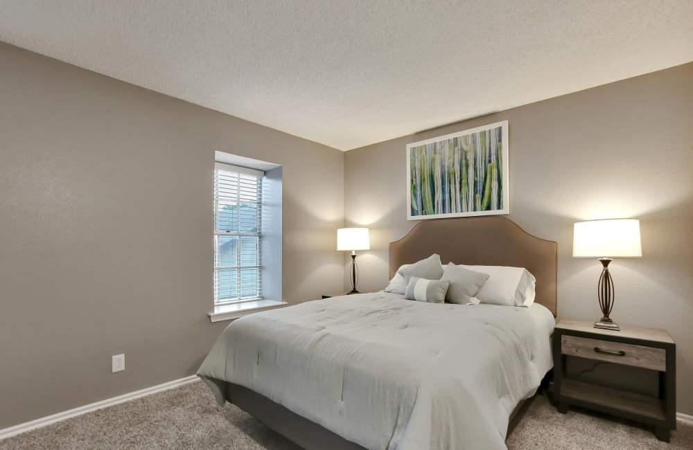 Apartment bedroom with carpet flooring at Parkwyn Townhomes in North Richland Hills,Texas