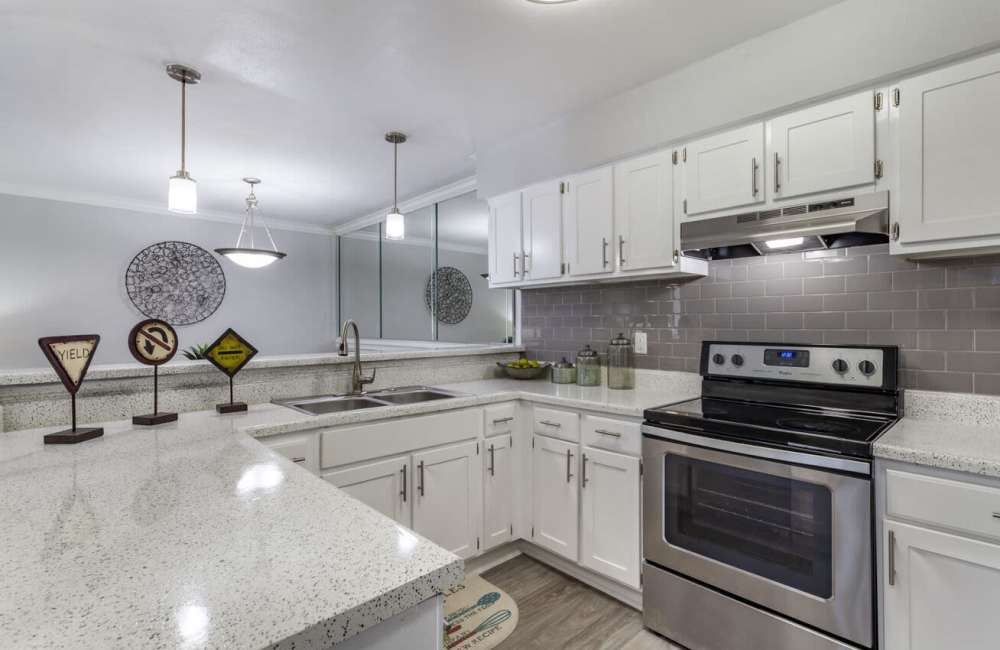Modern kitchen with quartz countertops and stainless-steel appliances at Rayfords Edge Apartments in Spring, Texas Friday, November 15