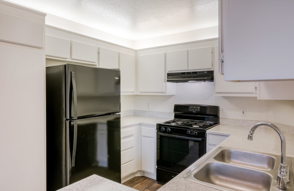 Modern apartment kitchen at Woodpark Apartments in Aliso Viejo, California