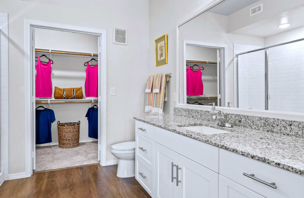 Large bathrooms with walk-in closets at Mariposa at Harris Road in Arlington, Texas