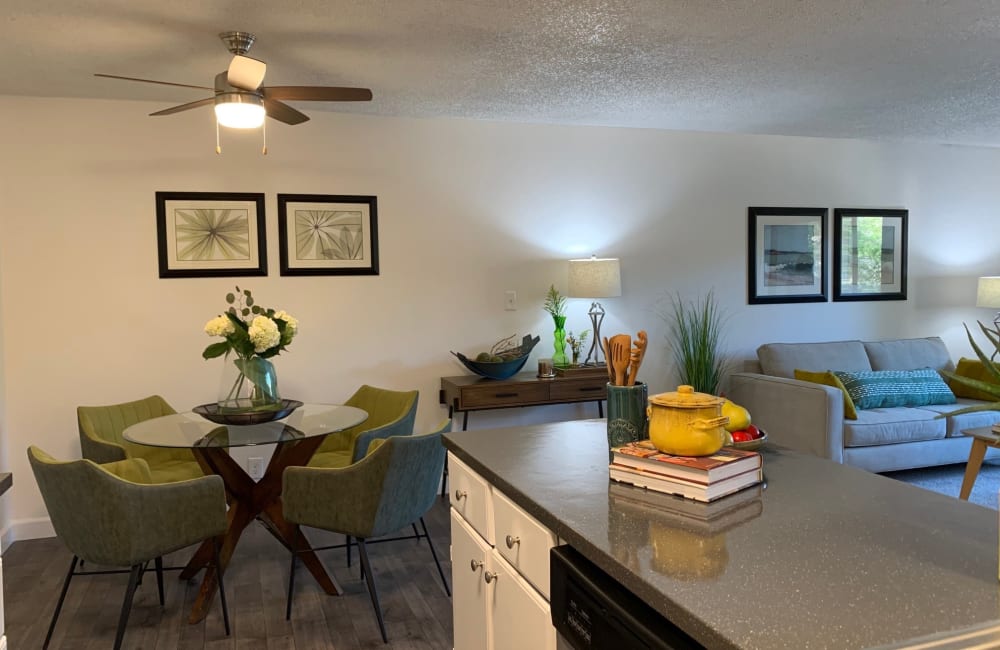 View from the kitchen towards the dining table and living room in a model home at Point Alameda in Alameda, California