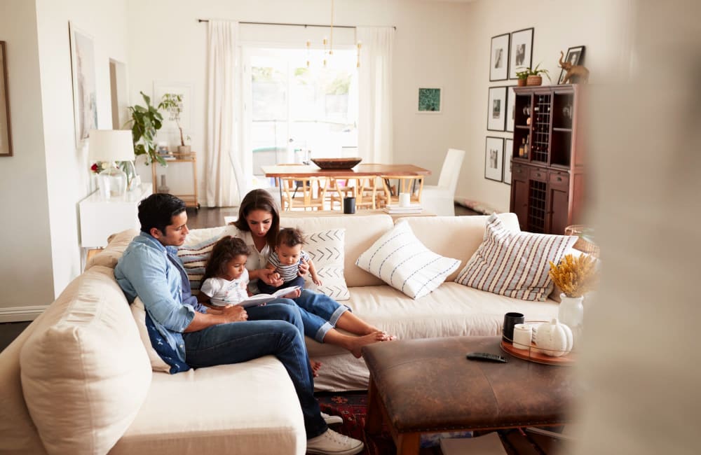 Happy family in living room at Montecito Terraces in Panorama City, California