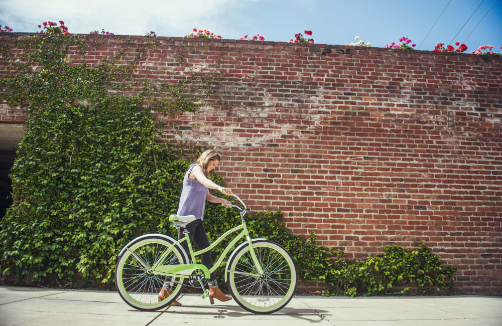 Resident walking her bike near Orchard City Lofts in Campbell, California