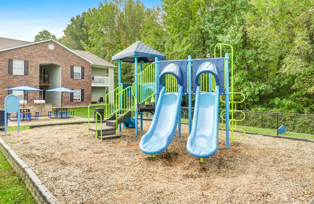 Apartments with a Playground equipped with a slide located at Highland Ridge Apartment Homes in High Point, North Carolina